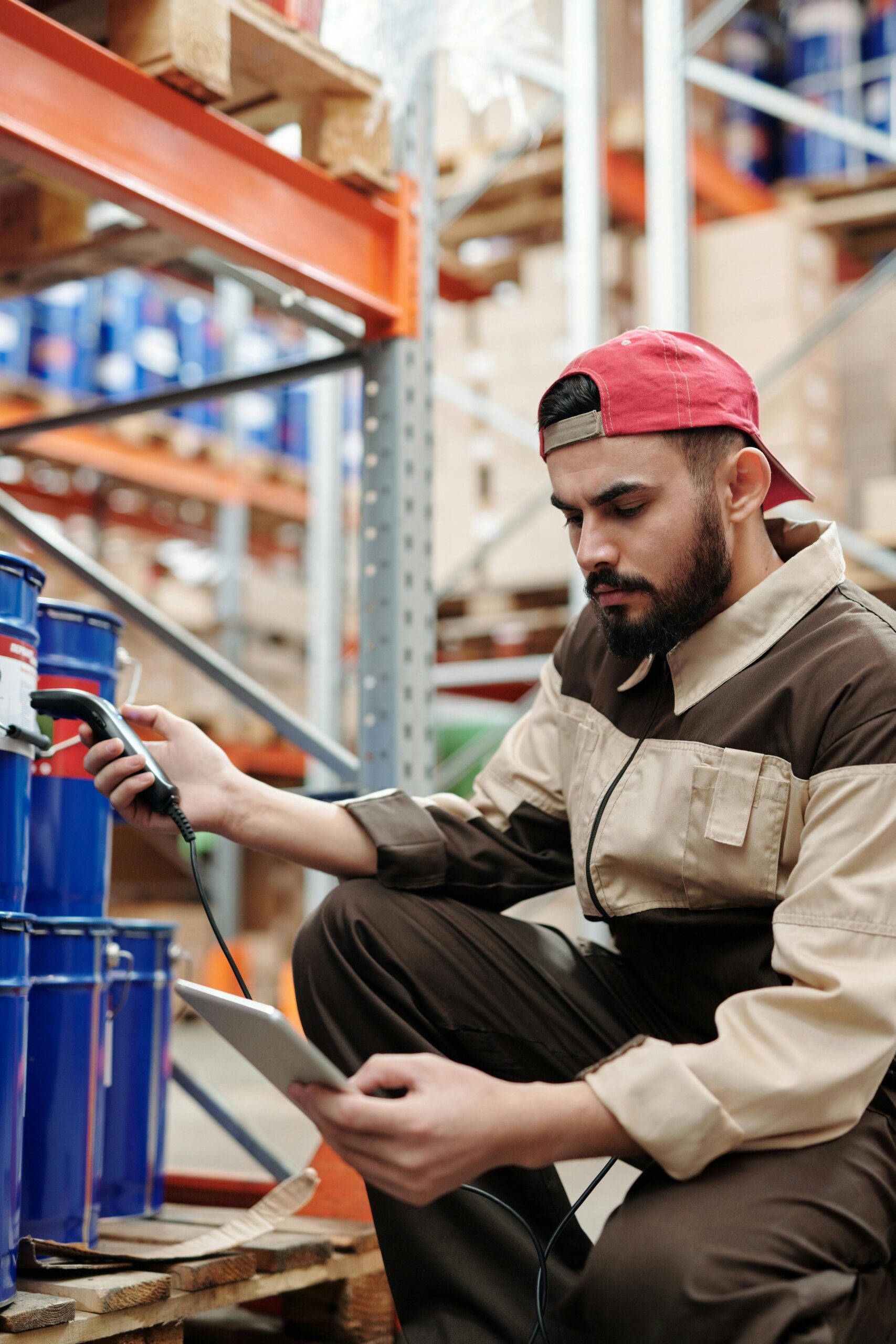 a man holding a tablet ans barcode scanner