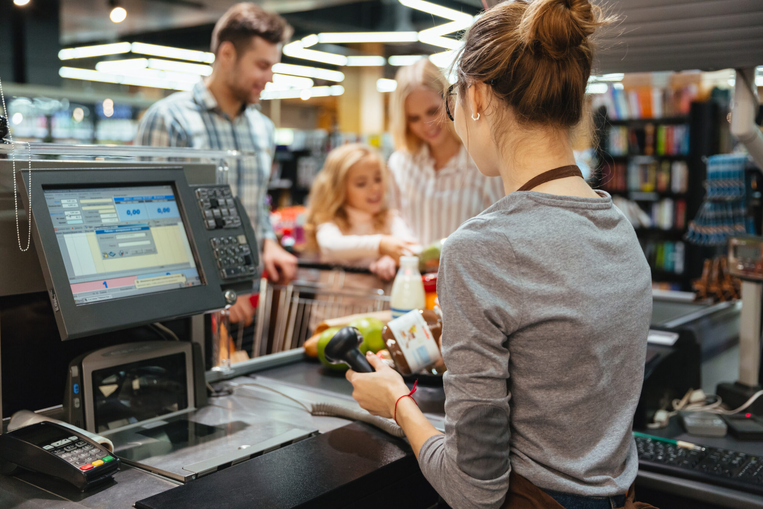 a woman at a cashier with scanners